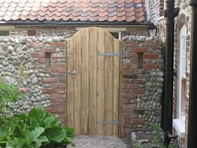 Custom built gate and wall courtyard garden design