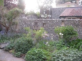 Cobble wall enclosing garden with niches for candles cobble wall with niches for candles