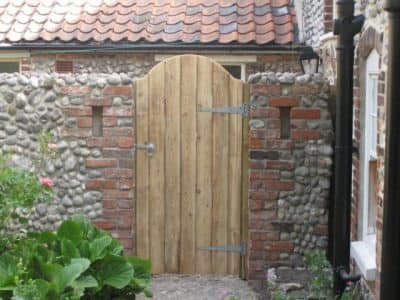 Custom built gate and wall courtyard garden design