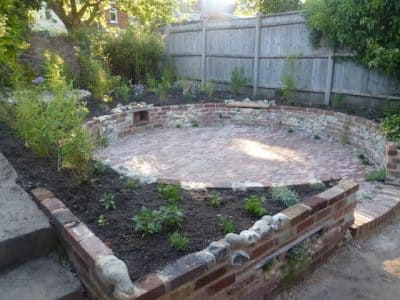 Raised beds surround the patio sunken patio garden
