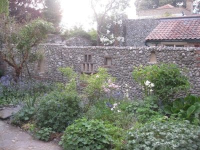 Cobble wall enclosing garden with niches for candles cobble wall with niches for candles